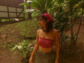 Bohemian Woman Taking a Mirror Selfie in Lush Tropical Garden