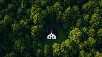 Fototapeta premium Aerial view of a quaint church surrounded by lush greenery