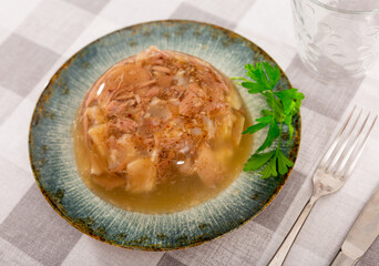Portion of homemade jelly pork meat in bowl, popular dish of russian cuisine
