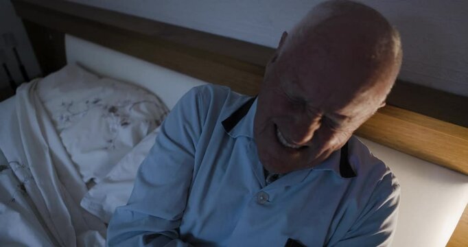 Senior man, bed with stomach pain, diarrhea or holding abdomen at night in home. Elderly male, bedroom and hurt with sore tummy, constipation or bloated with cramps, ibs or belly ache in the dark