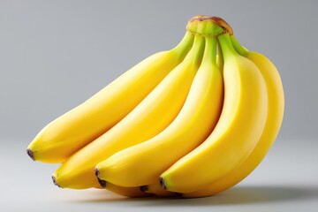 Fresh bunch of bananas displayed against a plain background.