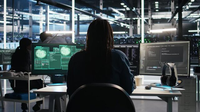 Panicked engineer in AI server facility reacts to hacking incident involving theft of sensitive data. Data center employee alarmed by computer virus triggered by security systems, camera A