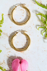 Gold Hoop Earrings and Jewelry with Bleeding Heart Flowers Flatlay
