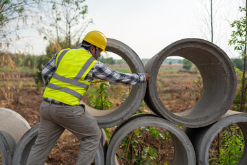 Infrastructure Inspection: A construction worker, clad in safety gear, meticulously inspects a...
