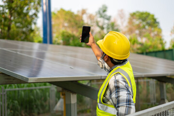 Solar Panel Technician Inspection: A diligent technician inspects a solar panel array using a...