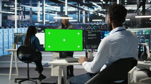 Data center IT expert uses isolated screen PC to apply deep learning node tree tech analyzing datasets. Server hub engineer uses visual programming on chroma key PC to identify data patterns, camera A