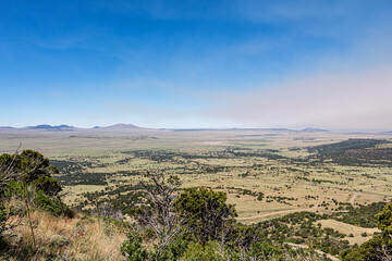 Serene landscape of the volcanic field seen from Crater Rim Trail at Capulin Volcano National Monument. Smoke in background is from wildfires at the time.