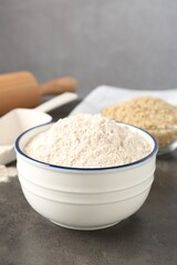 Brown rice and flour on grey table. Space for text
