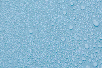 Many water drops on light blue background