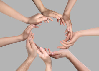 People making circle with their hands on grey background, closeup. Unity, partnership, cooperation