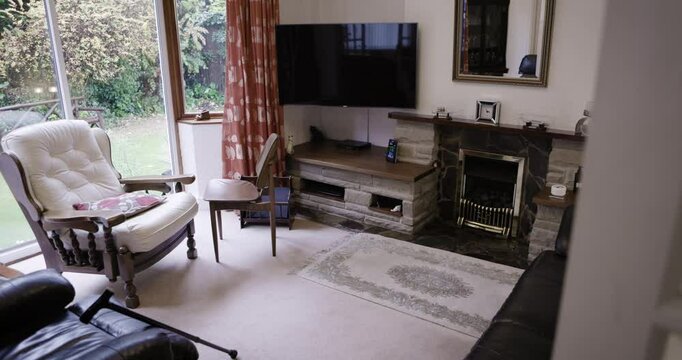 Room, help and walking stick in house, nursing home or empty living room and fireplace tv or sofa furniture. Retirement mobility, disability and cane aid in property, residential or interior design