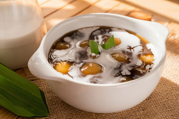 Closeup Of Sweet Sugar Dumplings In Coconut Milk In A White Bowl