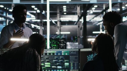 Server hub engineering team working together, using node tree software to optimize system health. Data center teamworking colleagues brainstorming equipment issues using AI visualization, camera B