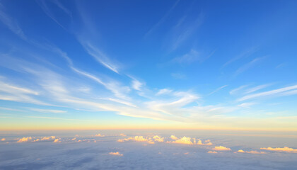 Obraz premium High-altitude cirrus clouds creating artistic patterns in a crystal clear blue sky, captured during golden hour 2