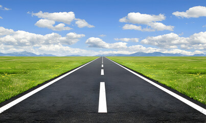Fototapeta premium Asphalt road stretches into distance, bisecting green meadow under a sky dotted with fluffy clouds