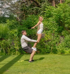 young man and woman doing fitness in the garden