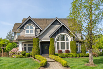 Two story stucco luxury house with nice spring blossom landscape in Vancouver, Canada, North...