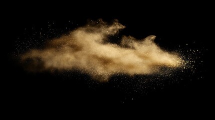 Gold colored powder explodes on a black background.  A cloud of particles floats and dissipates