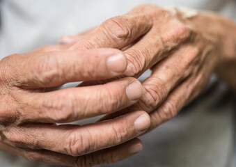 Fototapeta premium Close up of hands of an old man, shallow depth of field