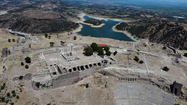 Aerial: Pergamon Acropolis with Ancient Temple remains during the day in Bergama, Turkey, orbit drone shot