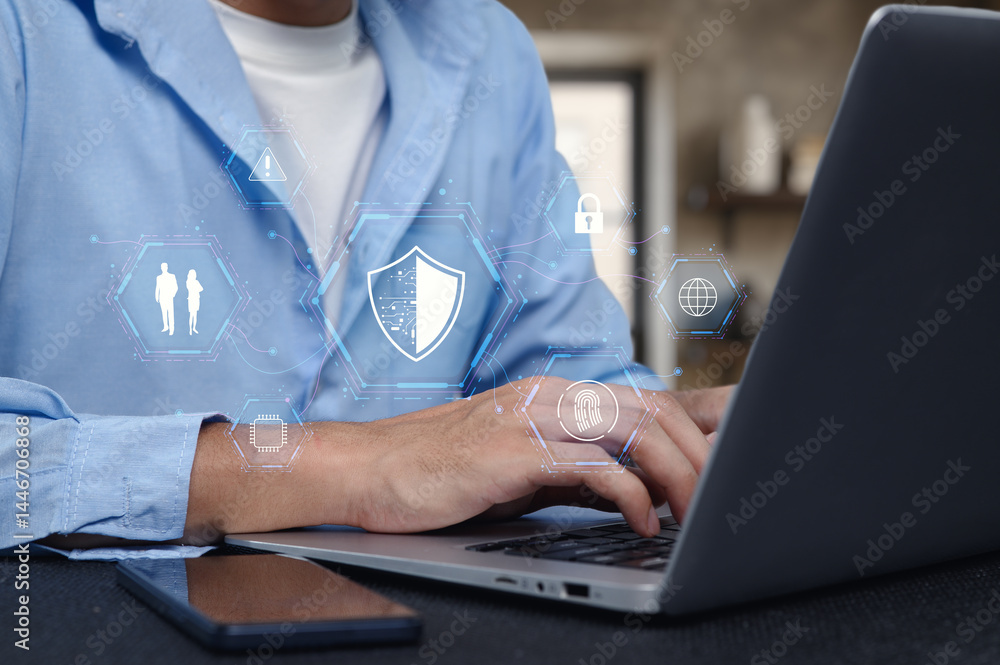 Poster professional using laptop with network security icons overlay