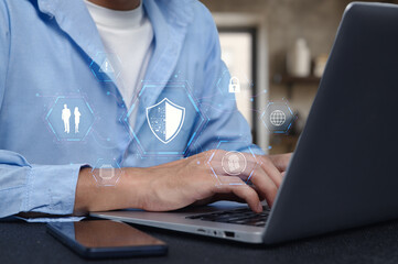 Professional using laptop with network security icons overlay