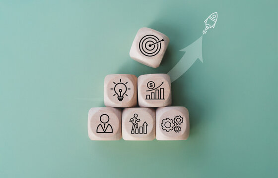 Rocket launching from wood cube with business icon, Start-up, Creativity, Big idea, Business goals management, Investment on new project to wealth, Company strategy target, Sustainable financial plan