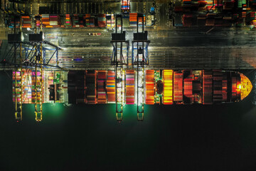 Aerial top view over container cargo ship at industrial import-export port prepare to load...