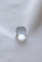 glass object sitting on top of a white sheet