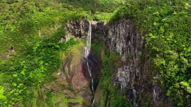 Picturesque flying over the mountain creek fall down from steep high cliff to wide green jungle valley. Cascade 500 Pieds waterfall also known as Cascade des Galets on Mauricius island in Indian ocean