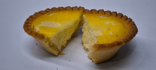 Egg tarts that are crispy on the outside and soft on the inside. Egg tarts that have a rich and creamy egg aroma. Egg tarts on white background.