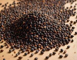 Naklejka premium Close-up of a pile of dark brown and black seeds. Image shows texture and detail of seeds.