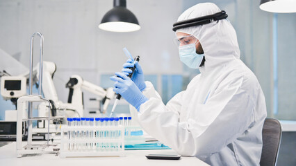 High-tech pharmaceutical laboratory, close-up of a scientist in full PPE using precision instruments to measure active compounds, sterile and futuristic environment.