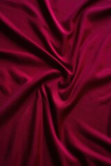 Fototapeta premium a close up shot of a maroon satin fabric. The fabric has a smooth, glossy texture and a deep, rich hue