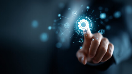 A man in a suit touches a glowing gear interface representing advanced system settings or automation.