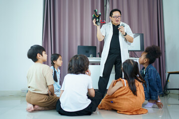 Fototapeta premium Group of diverse children enjoy learning about the STEM.