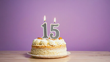 Sweet Fifteen Celebration: A delightful cake with two burning candles marks the special occasion of a fifteen-year milestone. The frosted cake and a backdrop of a soft hue create a festive mood.