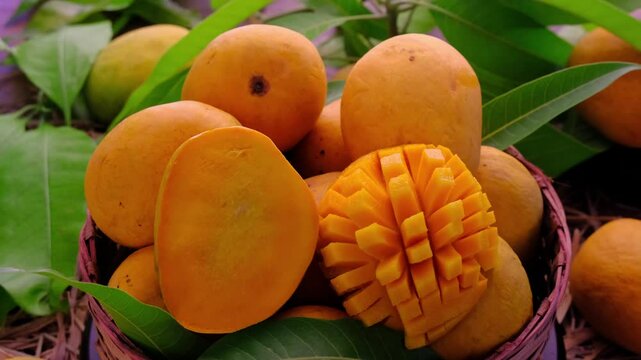 Mango tropical fruit with green leaf, Ripe mango in grass closeup