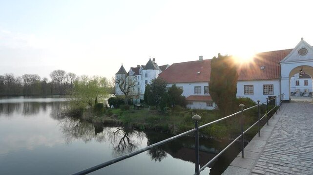 Glucksburg Castle, historic monument castle and castle lake, sunset point of View, North Germany near Flensburg.