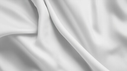Fototapeta premium Close-up of a smooth, elegant white fabric with soft, flowing drape.
