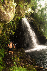Vertical shot of a male hiker wearing sunglasses walking next to