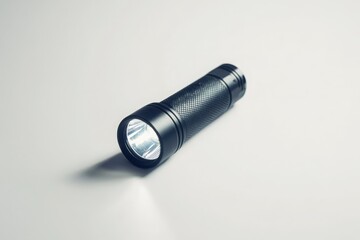 A single flashlight laying flat on white background