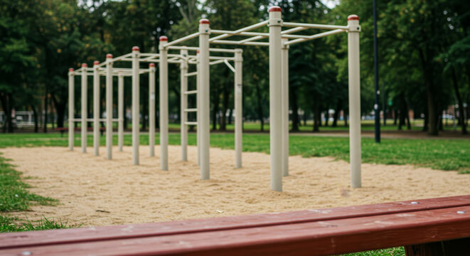 beige parallel bars in a lush green park