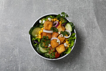 Fried tofu salad in a bowl, top view