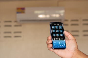 Smart Home, Smart Air Conditioning System, Smart Home Automation Application on Smartphones held by...