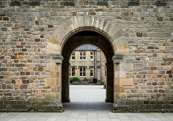 Obraz premium rustic stone archway leading to a stone building