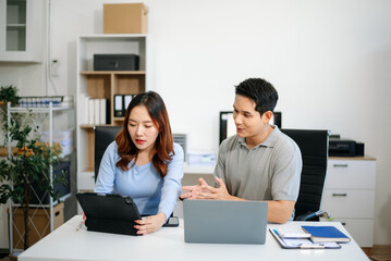 Female discussing new project with male colleague. Young woman talking in office