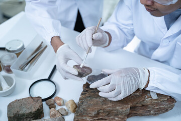 In the laboratory, research equipment rests on the table as scientists analyze rock samples, using advanced geology techniques to make groundbreaking discoveries in science. © Atthapon