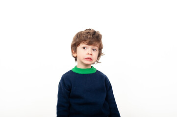 Boy in blue sweater smiles brightly