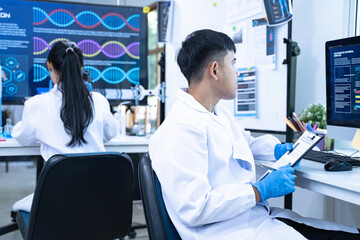 Scientist in laboratory conducting medical research using modern science and technology while...